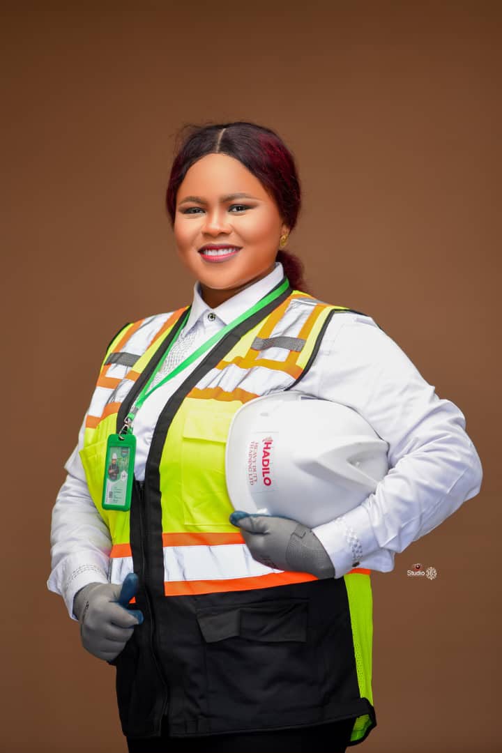 HADILO safety officer in branded PPE holding a hard hat